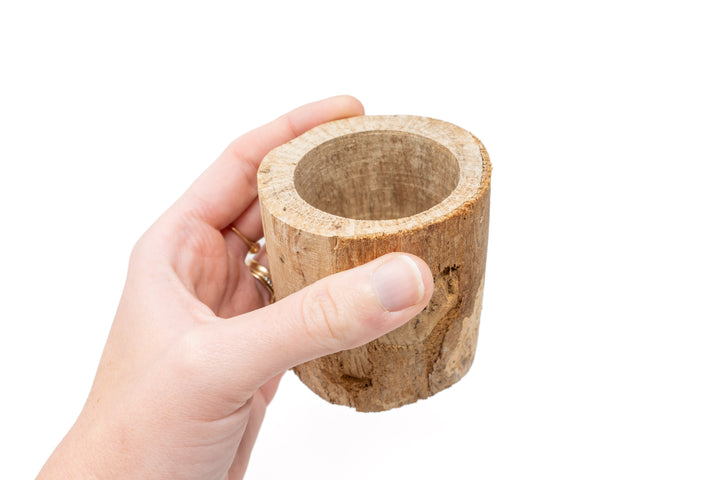 hand holding small driftwood container with varying wood shades