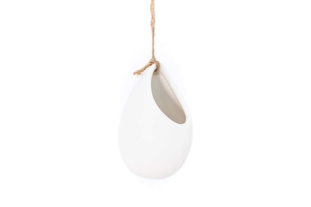small ivory ceramic vase hung with hemp string