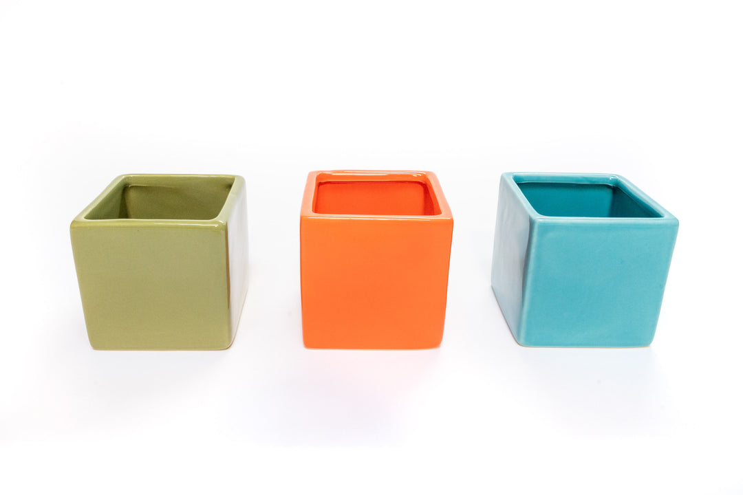 green, orange and blue ceramic cube planters