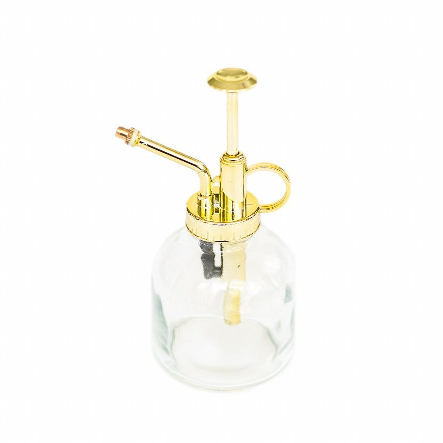 glass mister with gold colored spray nozzle