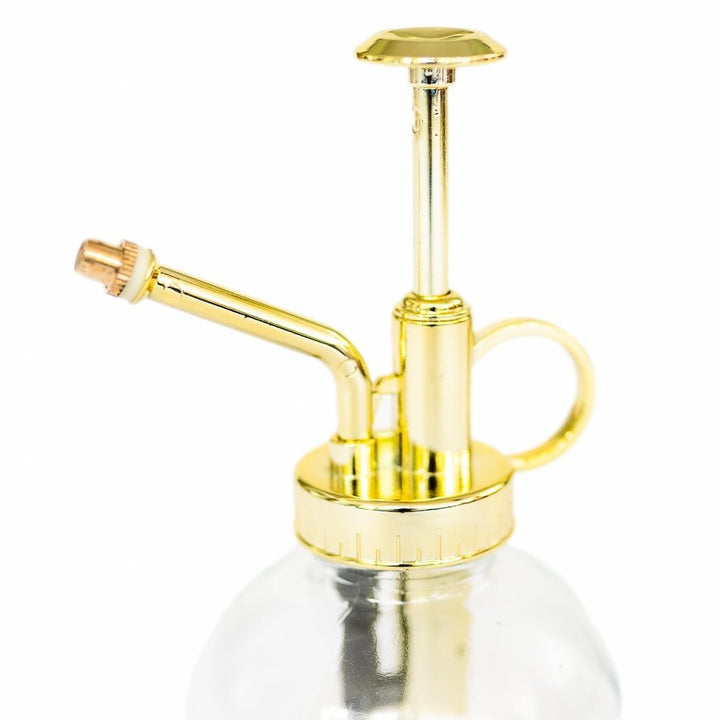 glass mister with gold colored spray nozzle