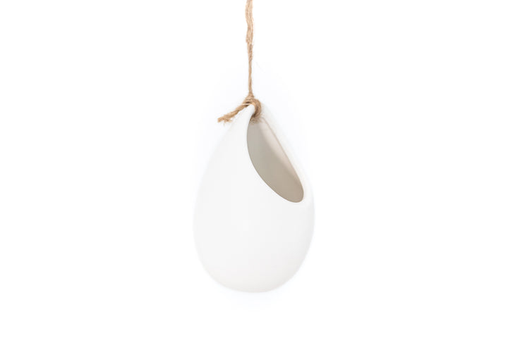 small ivory ceramic vase hung with hemp string